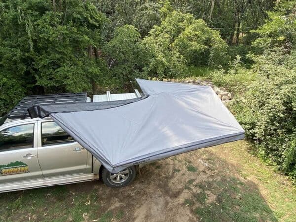 Image of Ostrich Wing Junior Awning setup on 4x4 Vehicle on grassed area