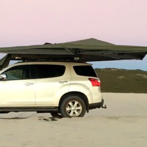Image of Ostrich Wing Awning setup on 4x4 Vehicle in beach sand